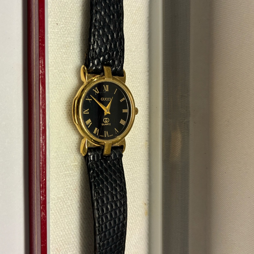 Gucci Black and Gold Roman Numeral Watch